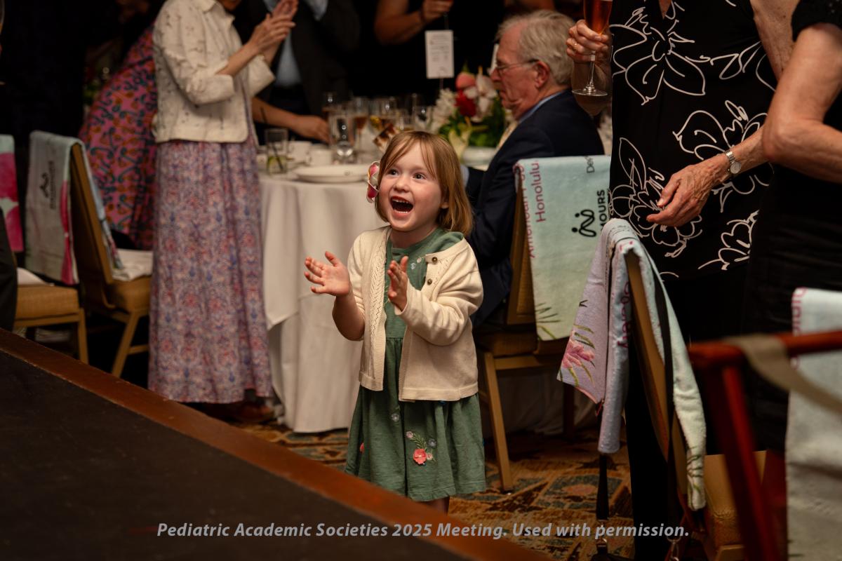 Dr. Bonnie Ramsey's granddaughter cheers in the audience at the APS Howland Gala.
