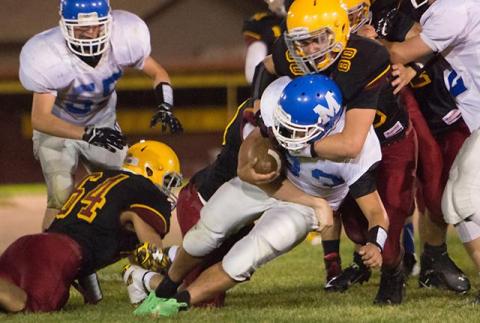 A high school football player falls during a game in 2013 in Kentucky. Flickr | Shannon Tomkins