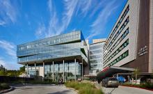 Photo of Seattle Children's Hospital surrounded by blue sky and whispy clouds